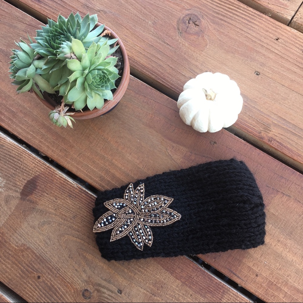 Black knitted head band with embellished flower